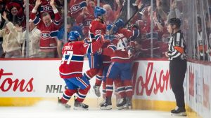 Montreal Canadiens' Cole Caufield (13) celebrates with teammates after scoring his 50th goal, during second period NHL hockey action against the Tampa Bay Lightning, in Montreal on Thursday, April 9, 2026. (Christopher Katsarov/CP)